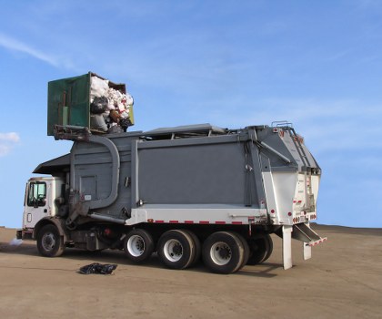 Workers loading a segregated skip for recycling in Seven Sisters
